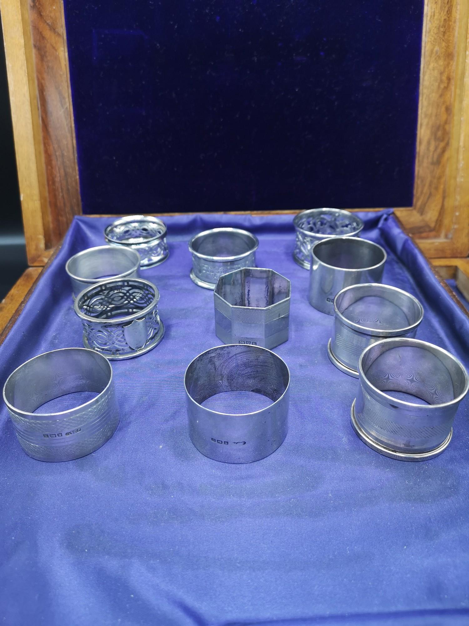 Collection of 11 silver Hall marked napkin rings 296 grams..