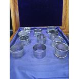 Collection of 11 silver Hall marked napkin rings 296 grams..