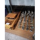 Shelf of metal chess pieces together with vintage car model.