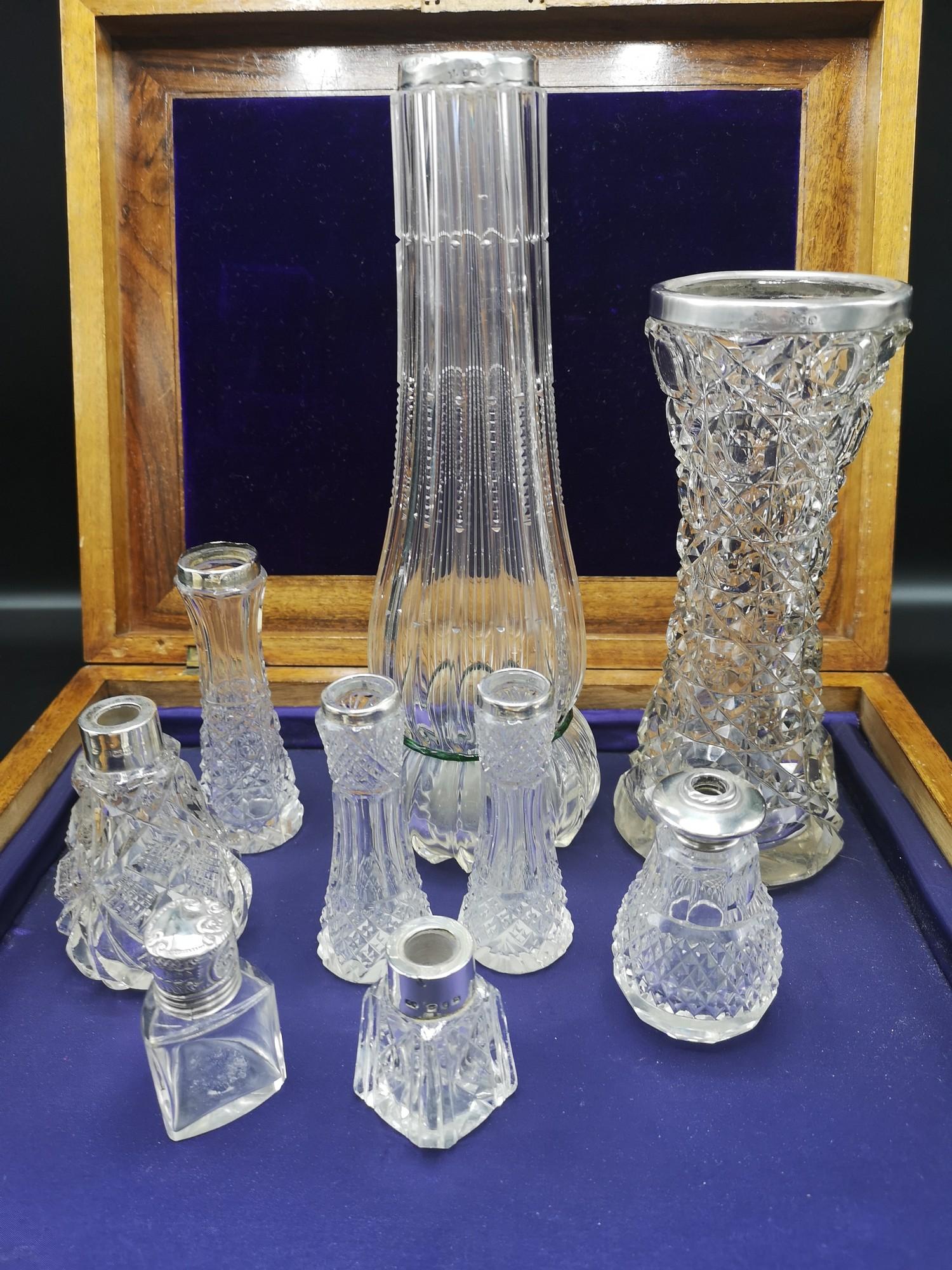 Large collection of silver rimmed bud vases.
