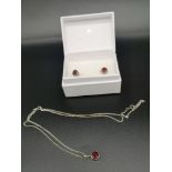 Silver chain and pendant set with matching earrings.