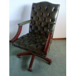 Chesterfield captains arm chair in green leather.