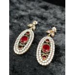 Silver red ruby colour stones and white stones drop earrings.
