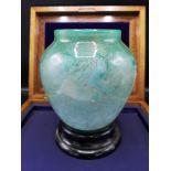 Large scottish glass Monart vase in pale green, green swirls with gold colouration..