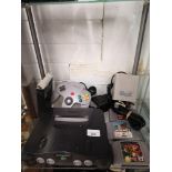Nintendo 64 with controller and games.