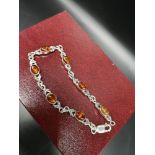 Silver hall marked bracelet set in baltic amber .