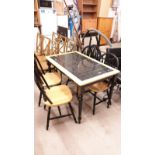 Modern kitchen table with black tile effect with 4 chairs.