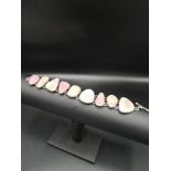 Silver hall marked birmingham ladys bracelet set with pink mother of pearls .