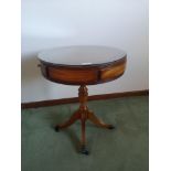Reproduction stunning drum topped table with brass tri feet.