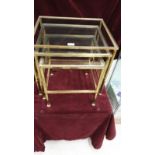 Nest of 3 brass tables with glass inserts.
