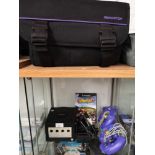 Ninetendo cube with games and controllers with fitted gamester casing.