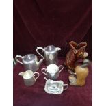 Selection of silver plated wares together with dart mouth pottery jug and cat figure.