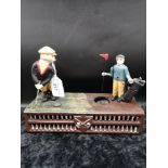 Cast iron golfers money bank.