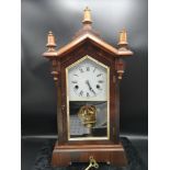 Vintage mantle clock with key and pendulum.