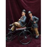 Laurel and Hardy large figure on 4 wheeler bike.