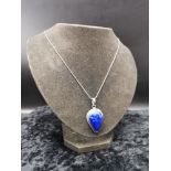 Large silver pendant set in blue stone on a silver chain