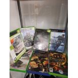 Shelf of xbox and playstation games etc.