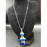 Large silver necklace set in 3 large blue stone pendant.