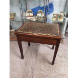 Antique piano stool with music sheets.