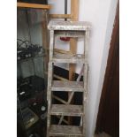 Wooden set of ladders together with metal set of ladders.