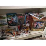 Shelf of Nintendo wii games to include zelda, Mario kart together with carry on set.