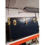 Large blue and brass bounded travel trunk with fitted interior.