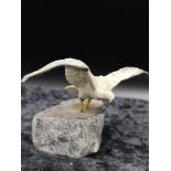 Cold painted bronze bird figure on a rock plinth signed Brixham.