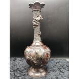 Oriental bronze vase with raised out dragon decoration.