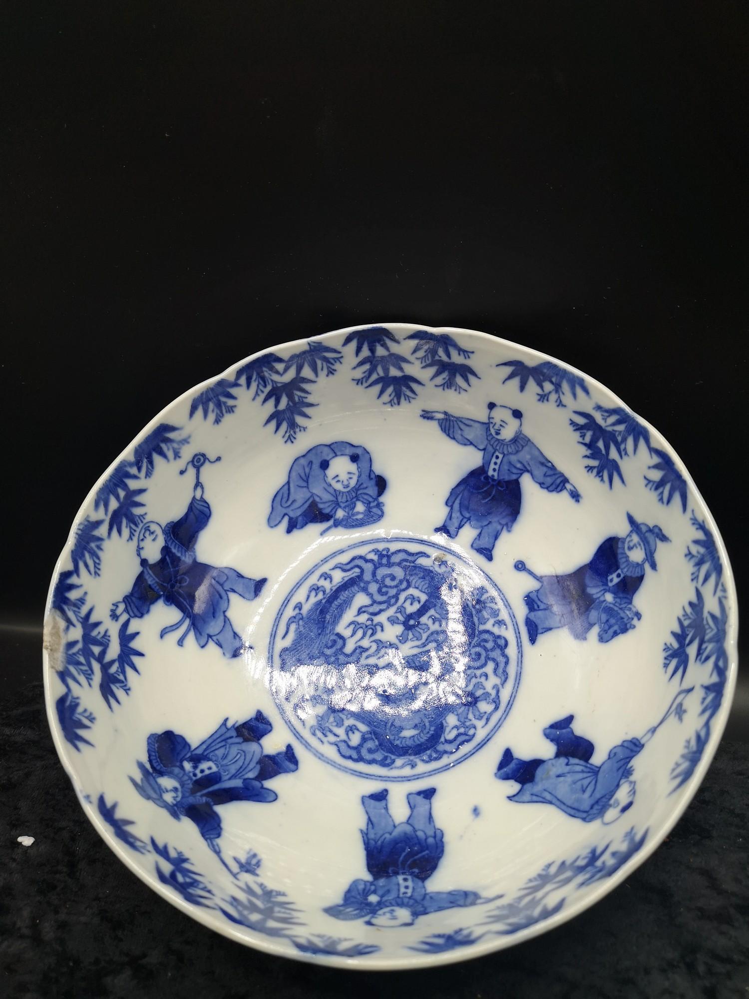 Chinese bowl depicting gathering in blue and white form with character bstanp to base. As found.