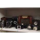 Large shelf of assorted bellows camera etc.