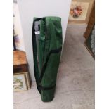 Folding camping bed in fitted bag.