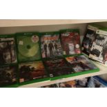 Shelf of xbox one games, and 2 xbox 360 games.