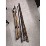 Lot of vintage fishing rods together with lot of drain rods.