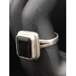 Silver ring set with black stone.