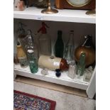 Shelf of old bottles, soda syphine, ginger beer stone ware bottle. Etc.