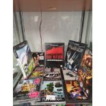 Shelf of nintendo cube games , playstation 1 games etc .
