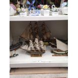 Shelf of novelty ship models .