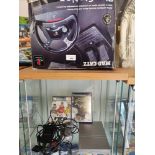 Playstation 2 slim line with games together with steering wheel.
