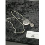 Silver necklace with fob and locket .