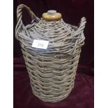 Vintage flagon support in wicker binding.