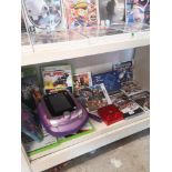 Shelf of assorted xbox games nintendo ds game etc .