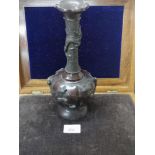 Large Oriental bronze dragon vase with raised out bird decoration.