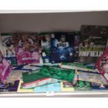 Shelf of rugby programmes and tickets etc .