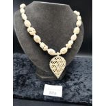 Large Statement bone necklace set with elephant foliage etc .