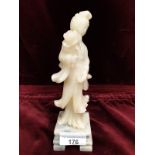 Oriental Early soap stone figure sat up on a base.