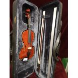 Small violin in fitted case with bow.