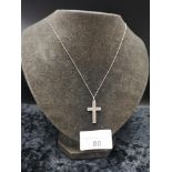 Silver necklace with silver cross pendant.