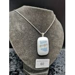 Silver necklace set with large mother of pearl style stone.
