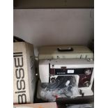 Singer sewing machine together with bissell item.