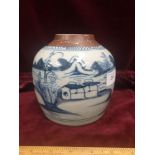 1900s Chinese blue and white vase with browned top depicting housing and mountain scene.